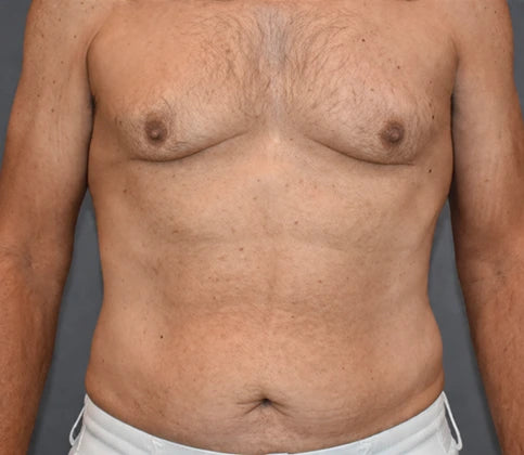 Man with a bare torso against a gray background