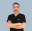 Man wearing a black shirt with a small logo on a light blue background